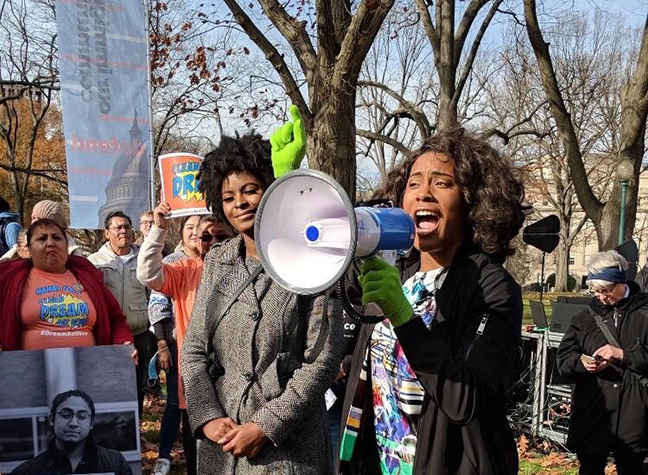 Immigrant rights activist and storyteller Denea Joseph speaking at a rally.