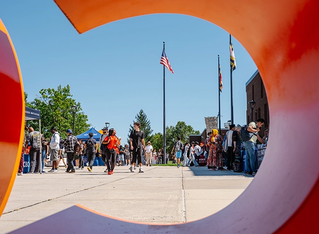 Students walking on campus, enjoying time together outside.