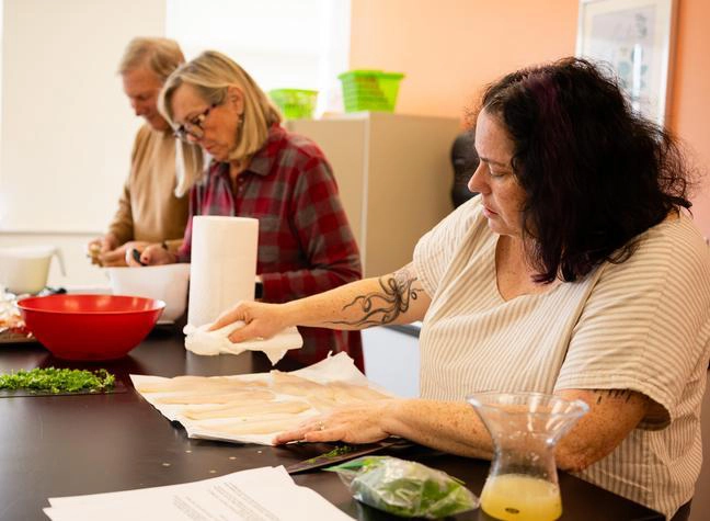 A group prepares a community meal together.