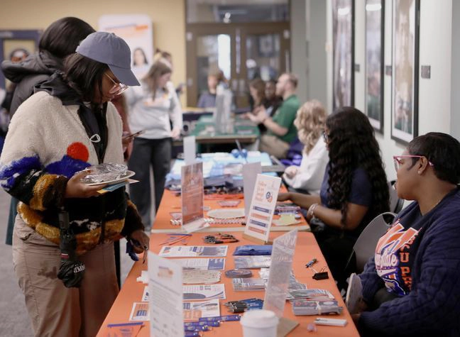 A student asks for an information brochure about CCBC's transfer programs while attending the Transfer Fair.