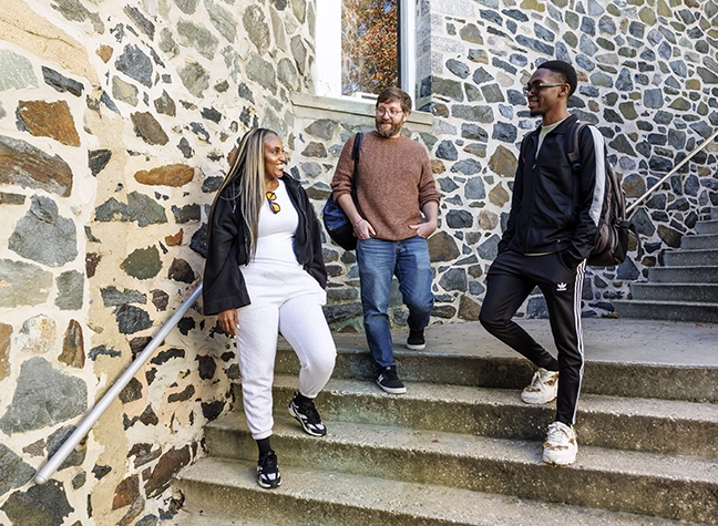 Three students walking down the stairs to the Office of Student Engagement on the Catonsville campus.