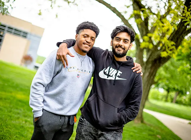 Two students give each other a high-five in celebration!