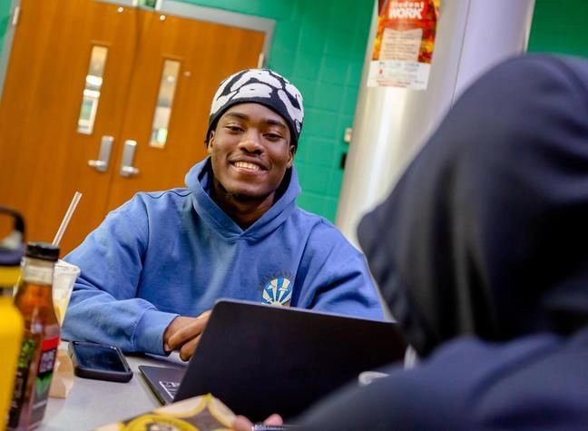 A student finishes up his degree planning with peers.
