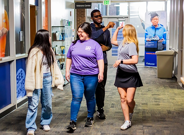 Student Engagement leaders walking down the hallway, laughing.
