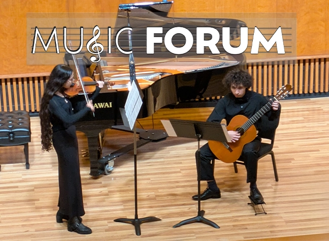 Two students performing instruments onstage