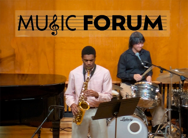 Two students performing instruments onstage