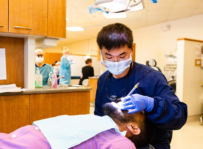 Photo of dental hygienist working on patient.