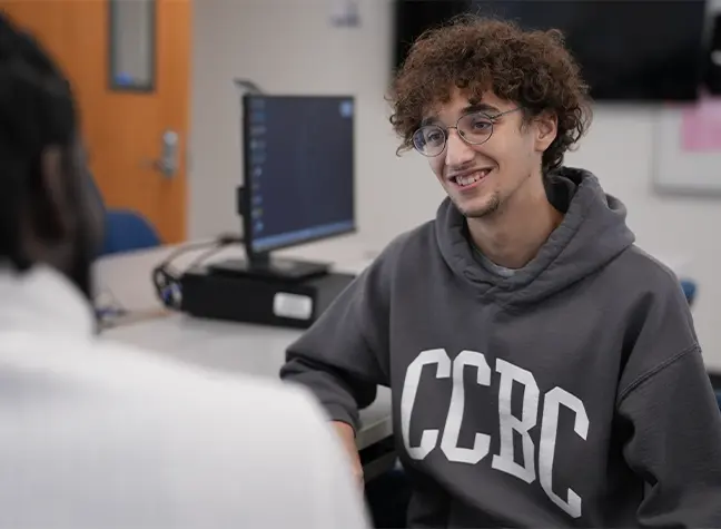 CCBC student in classroom talking to professor
