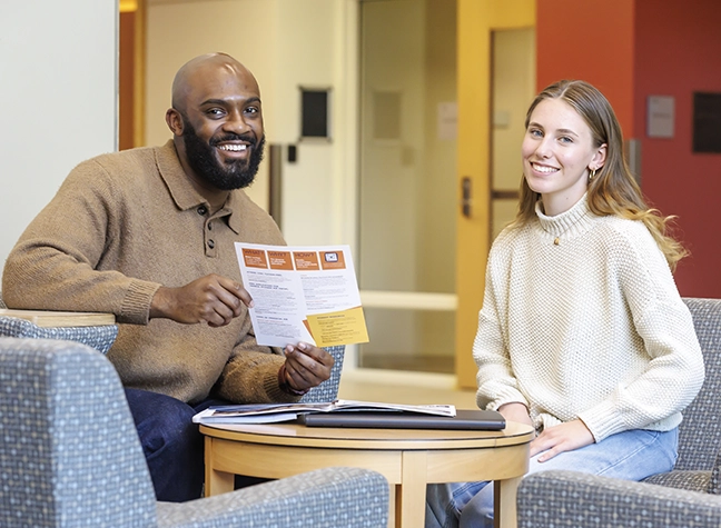 Two students reviewing a document together