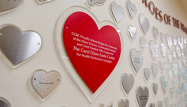 Heart shaped wall plaques with names of donors printed on them
