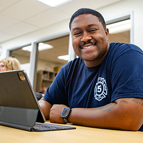 Student in class working on his tablet