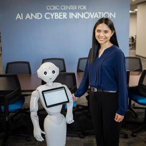 Nicole is standing next to Pepper, the CCBC AI robot.