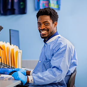 Male student sitting down using medical lab technology
