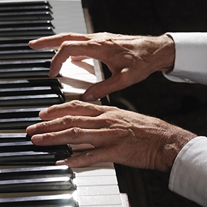 Close up of hands playing piano