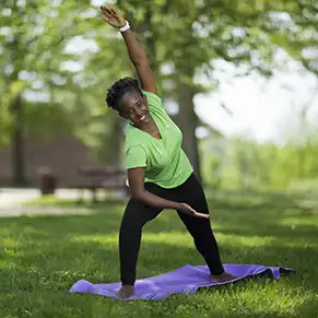 Student outside practicing yoga