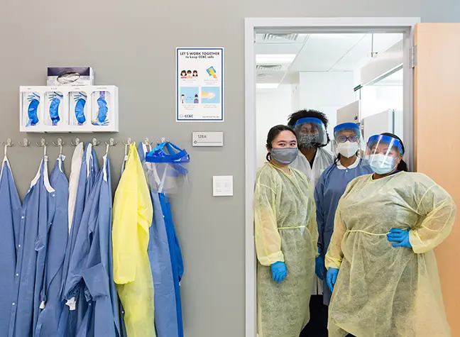 photo of nurses dressed in surgical gear.