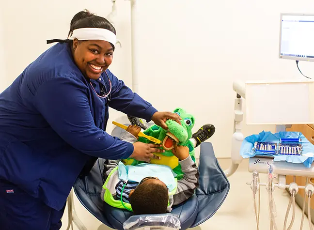 Dental hygiene student working with a child patient.