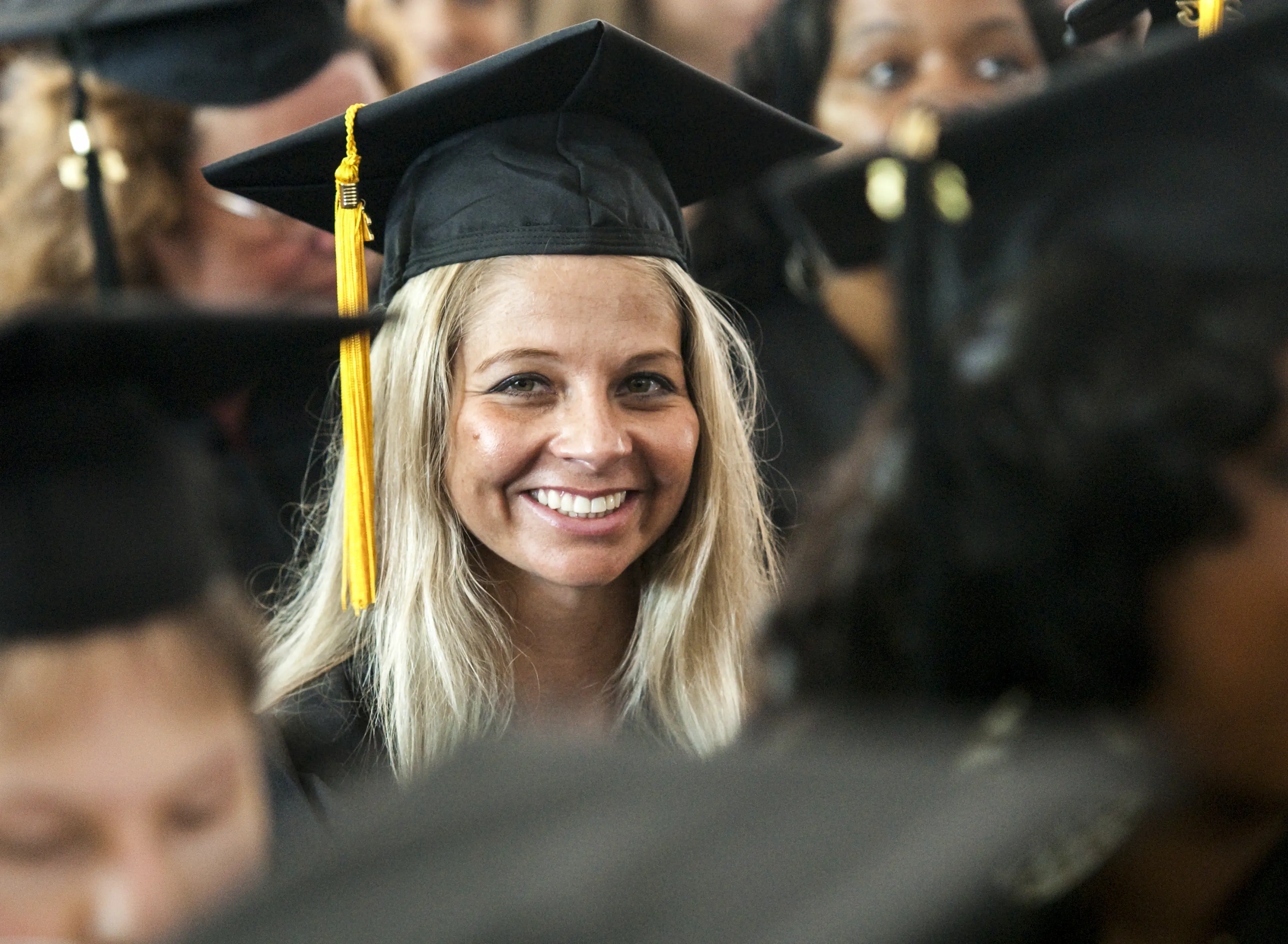 Graduate student smiling at graduation