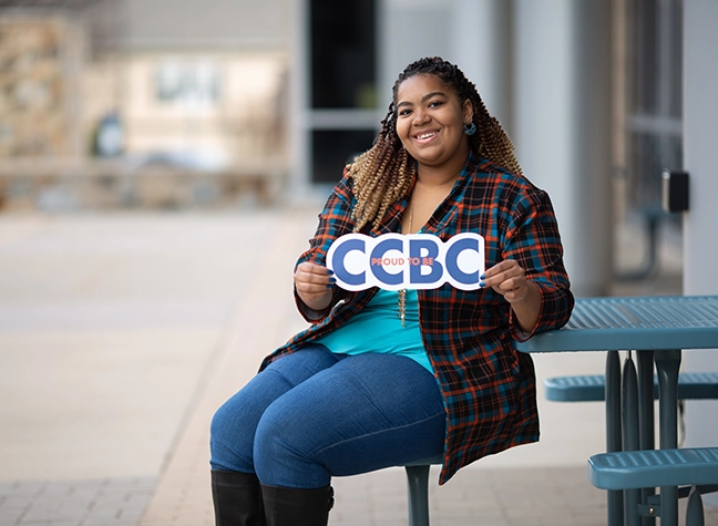 Student holding CCBC sign
