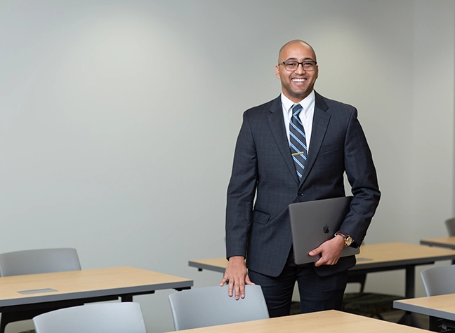 Photo of man in classroom wearing a suit