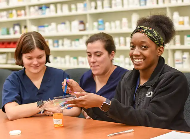 Two students working in the pharmacy technology lab