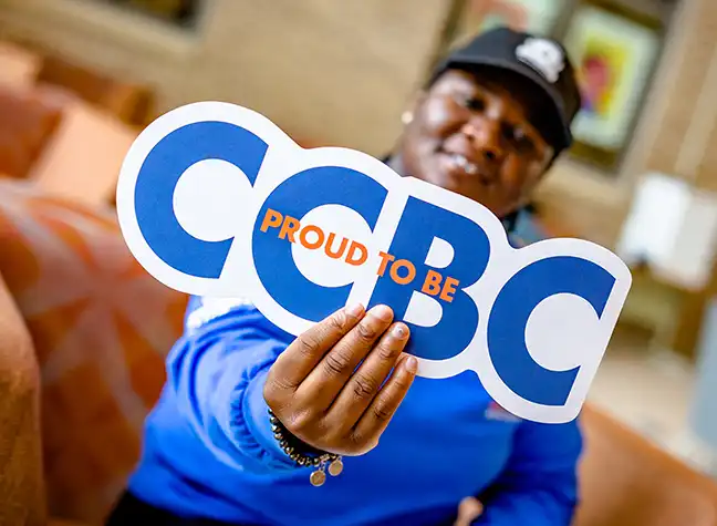 Student holding sign