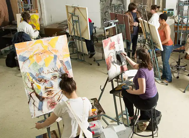 Students painting in art studio