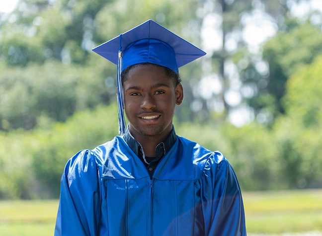 Graduate smiling in cap and gown