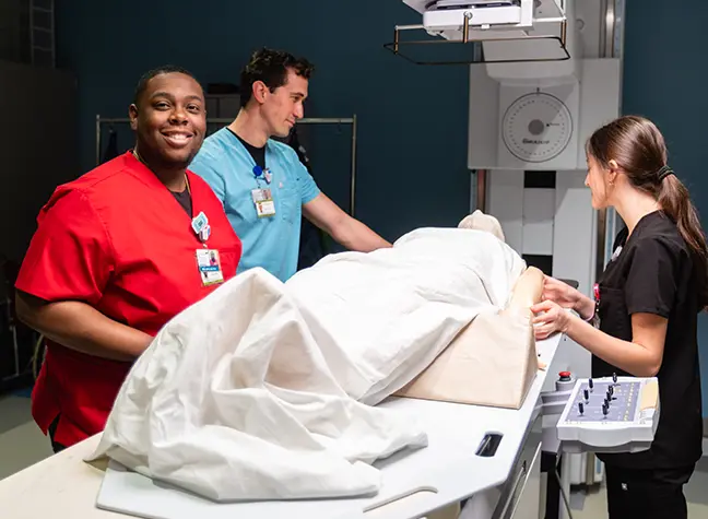 Three Radiation Therapy students working in lab