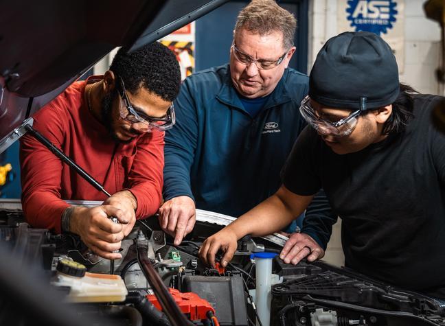 Automotive tech students working on car