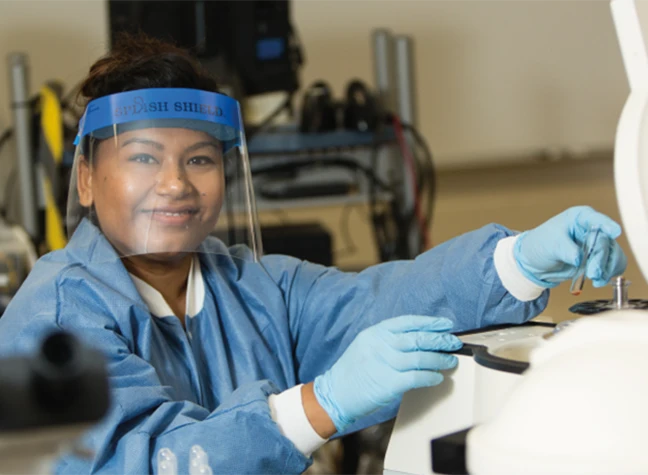 Female student with face shield and medical lab equipment