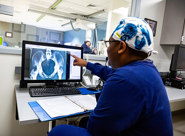 Student examining x-ray on computer