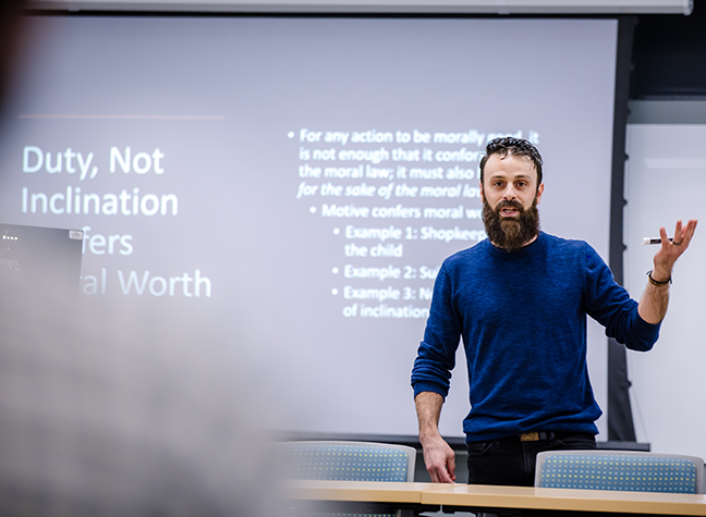 Professor teaching in front of a screen