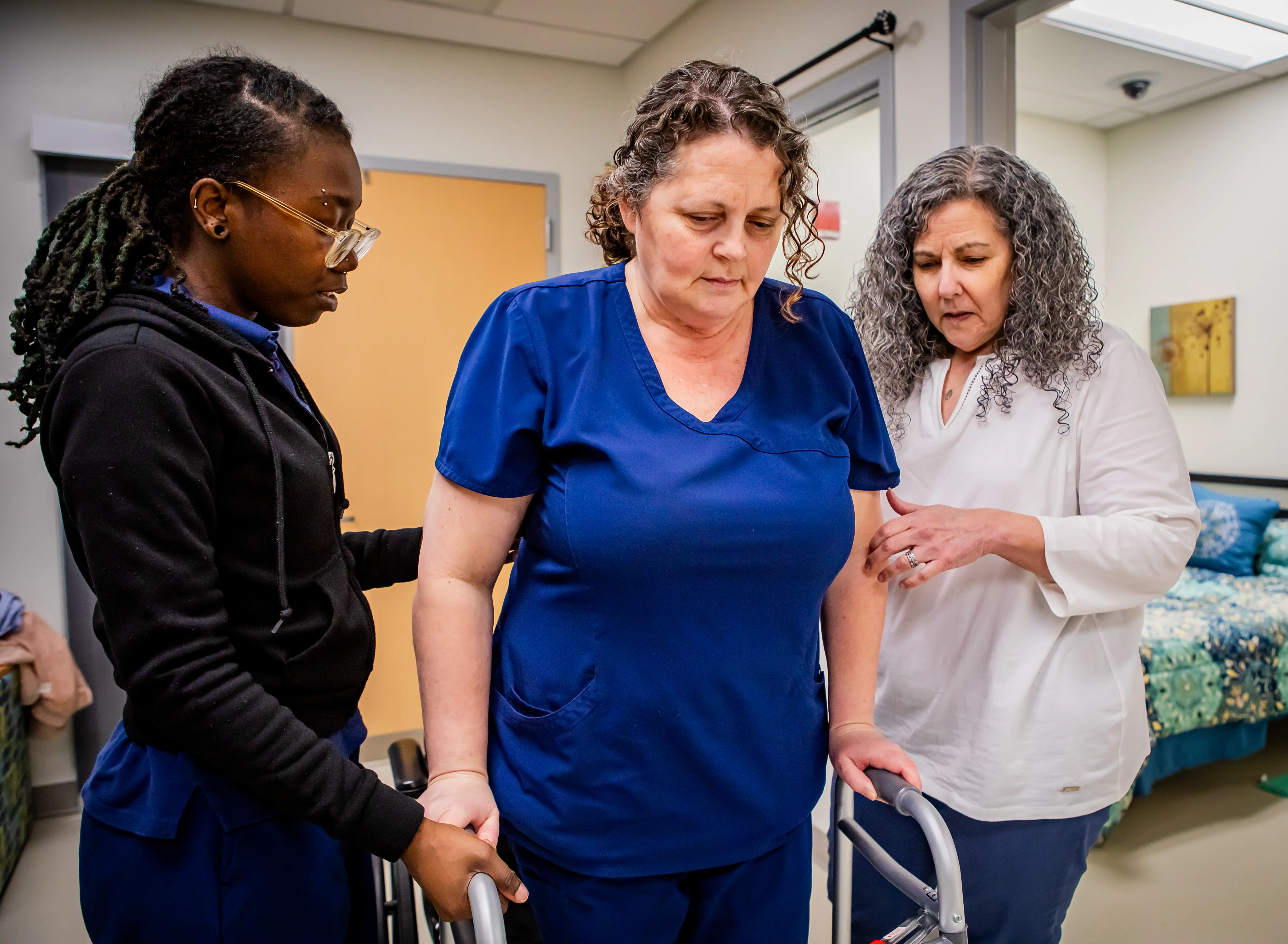 Occupational therapy assistants helping a patient