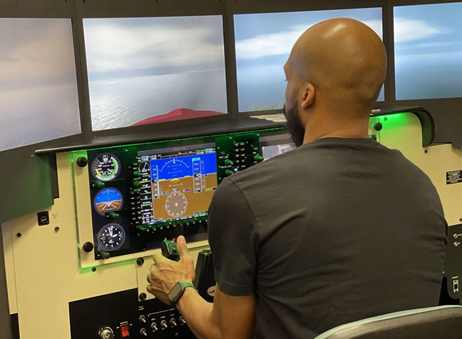Student using the aircraft simulator