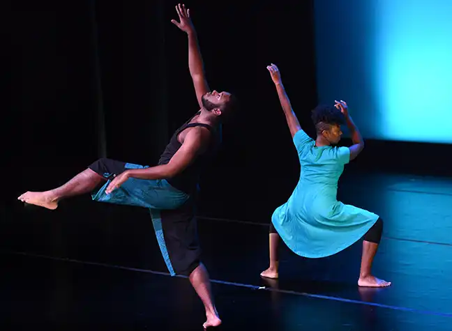 Two CCBC dance students performing on stage