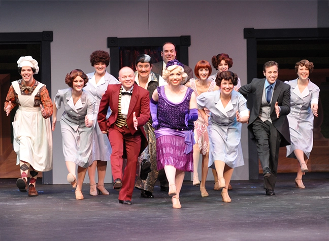 Costumed players dancing on stage