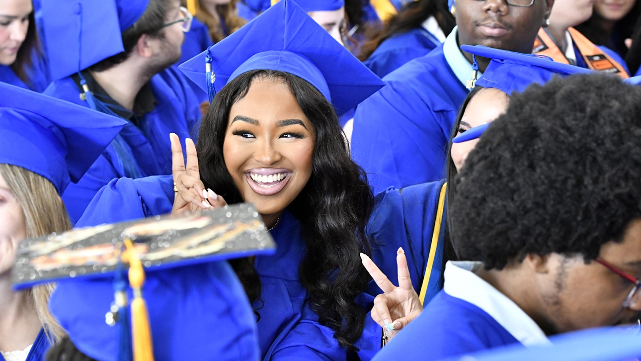 A graduating student smiles as CCBC's Commencement ceremony comes to an end.