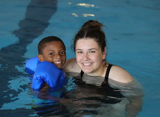 Lady and kid posing in swimming pool