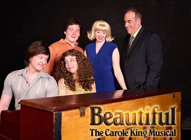 People gathered around a piano smiling